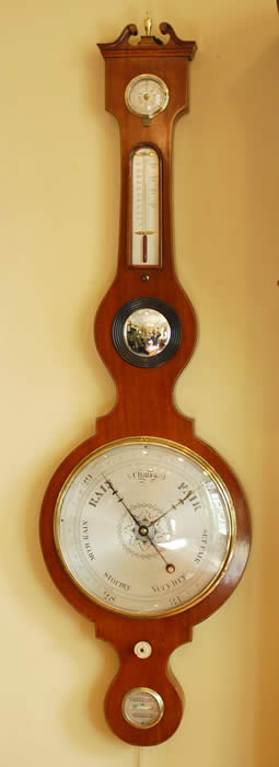 An ebony and boxwood strung , mahogany wheel Barometer with an 10" engraved and silvered dial with brass bezel and covered with a convex glass, a silvered Thermometer scale with red alcohol tube. The convex 'Butlers' mirror with ebonised reeded bezel .Below the barometer dial is the ivory knob for positioning the brass hand (Yesterdays reading) and at the bottom is a spirit level engraved with Warranted Correct . Circa 1870 