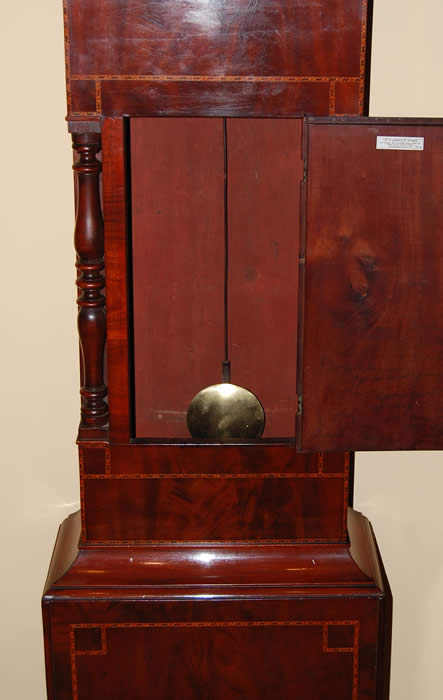 This is very decorative 'Rocking Ship' Longcase clock of 8day duration with a pleasant bell strike for the hour . This clock has in the arch of the dial a Ship that Rocks from side to side with each tick of the clock , this feature was popular when the clock was made as there were no moving images elsewhere to be seen .The dial also includes a calendar and seconds hand with all hands being the original Brass fret cut and punch decorated . The cabinet is of highly figured mahogany with box-line inlays , turned columns to both the hood and to the trunk . Standing on small bracket feet . David Bevan of Hirwain is listed in the Slaters Commercial directory of 1858 , this clock dates to around the 1840-50's . 