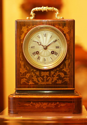 A fine marquetry inlaid rosewood mantel clock with very good colour and patina with small lenticel below the decorative handle to view the original silk suspension escapement , The 3 inch dial is slivered and has an engine turned decoration to the center with Roman numerals and the makers name stamped in .Boxwood stringing to all sides of the case and floral marquetry inlays . A fine French 8 day movement striking on a Bell , polished blue steel Breguet Hands . Henry et cie Paris is recorded working in the early to mid 19th Century and this clock would date to circa 1850 . Standing 25cms small ! (with Handle raised) 16.5cms wide and 13cms deep . 